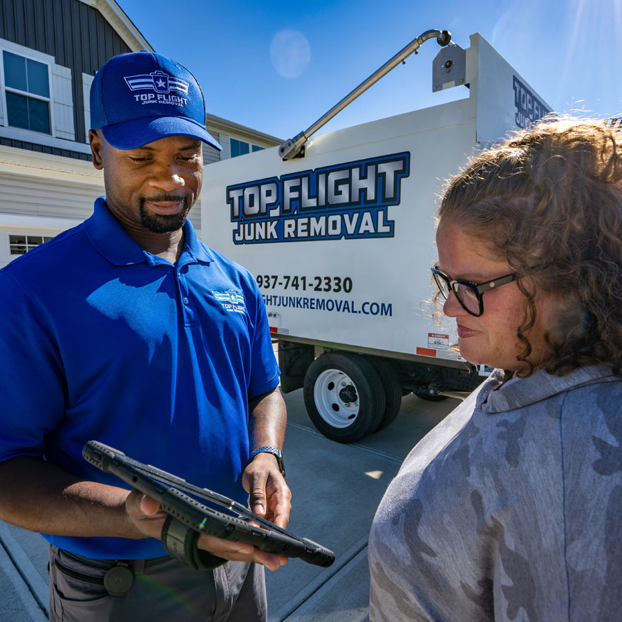 Top Flight Junk Removal experts talking to client